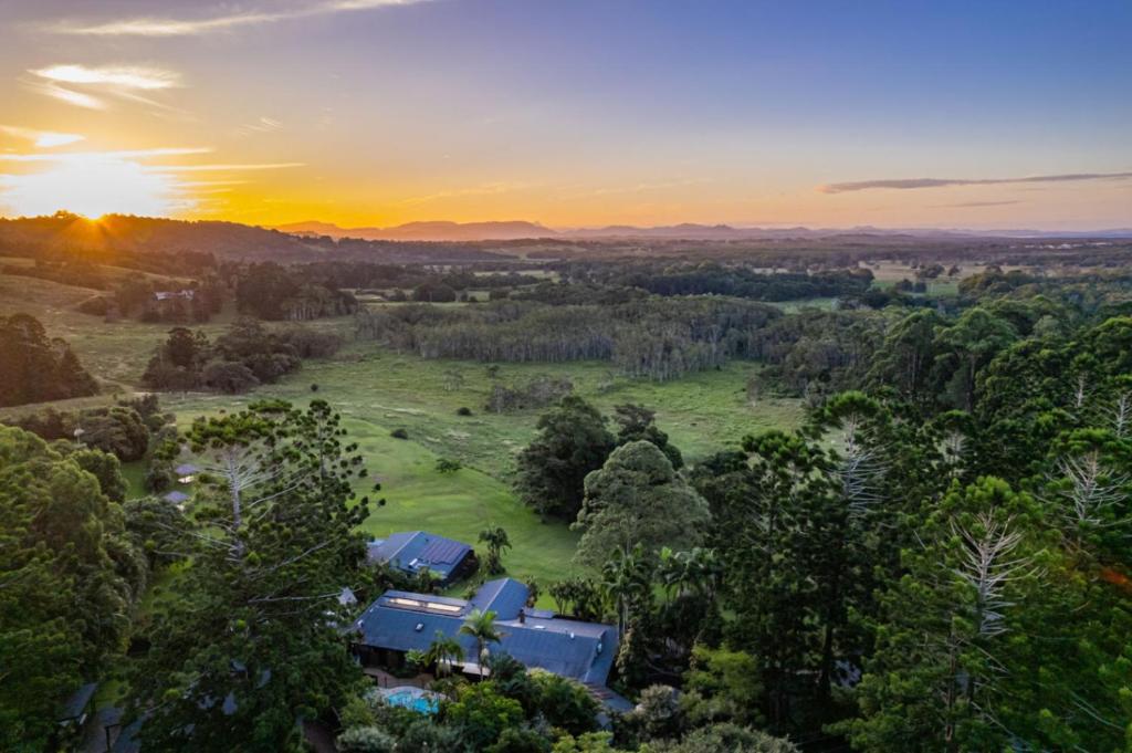 an aerial view of a house in a field with the sunset at Cape Byron Suite 5 Private Suite with Ensuite in Byron Bay
