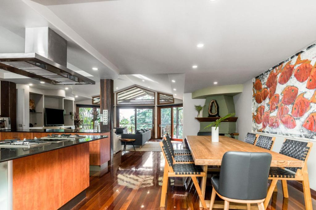 a kitchen and dining room with a wooden table and chairs at Cape Byron Suite 5 Private Suite with Ensuite in Byron Bay