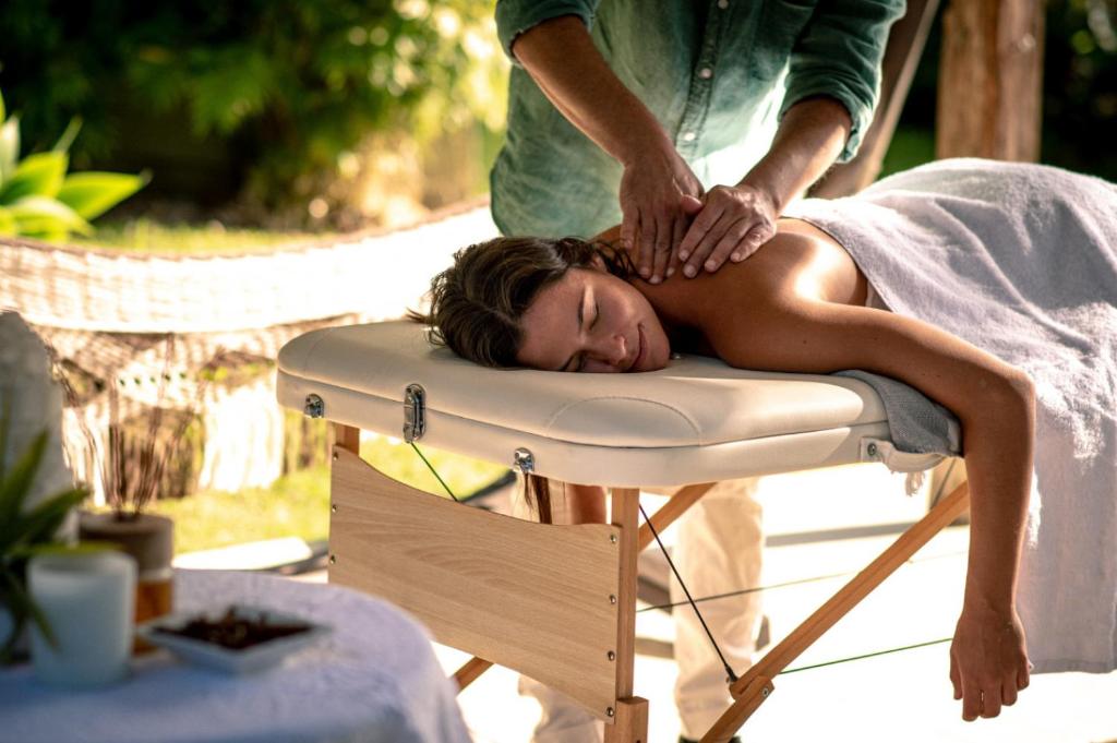 a woman getting a massage on a chair at Cape Byron Suite 5 Private Suite with Ensuite in Byron Bay