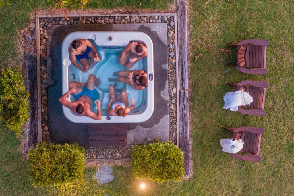 an overhead view of people in a swimming pool at Cape Byron Suite 5 Private Suite with Ensuite in Byron Bay