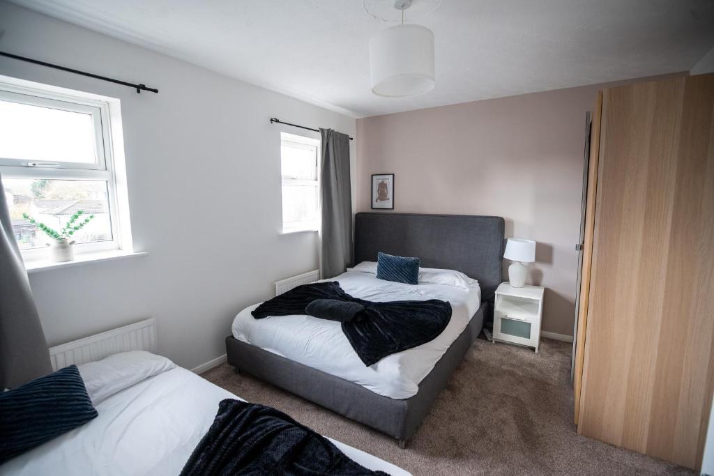 a bedroom with two beds and a window at Stunning Cardiff Wharf View 4 Bed Free Parking in Cardiff