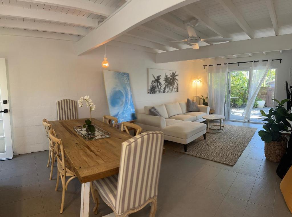 ein Wohnzimmer mit einem Holztisch und einer Couch in der Unterkunft Casa de Sol Noosa Heads in Noosa Heads