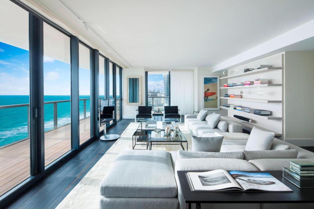 a living room with a view of the ocean at W South Beach in Miami Beach