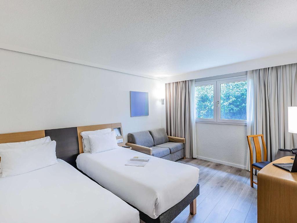 Кровать или кровати в номере Novotel Setubal