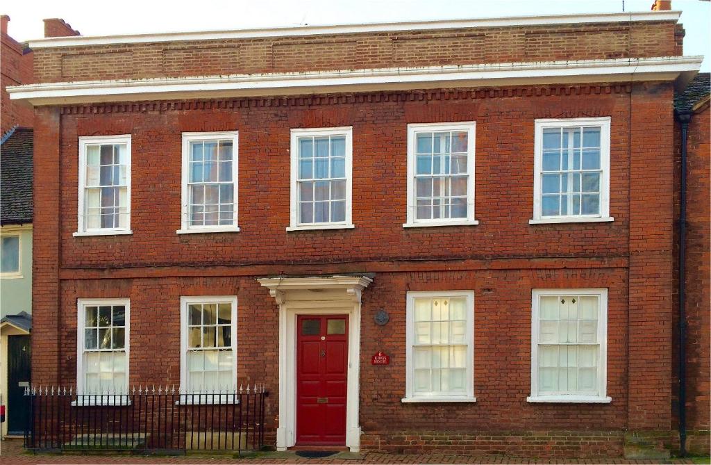 a red brick building with a red door at Kings House Wokingham in Wokingham