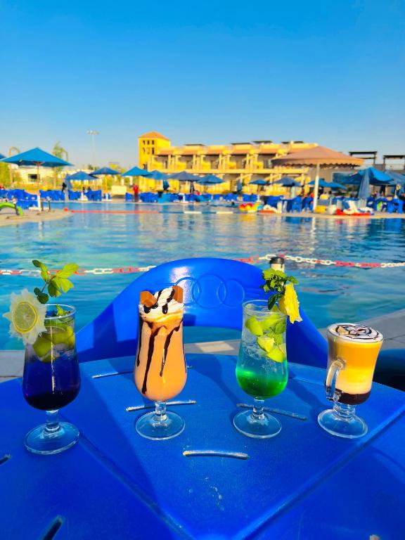 a table with drinks on it next to a pool at Ramage Hotel & Resort in Cairo