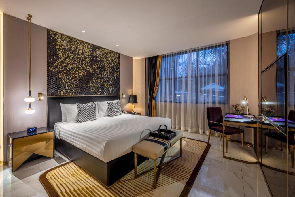 a bedroom with a bed and a desk and a window at Glee Nairobi, a Preferred LVX Hotel in Nairobi