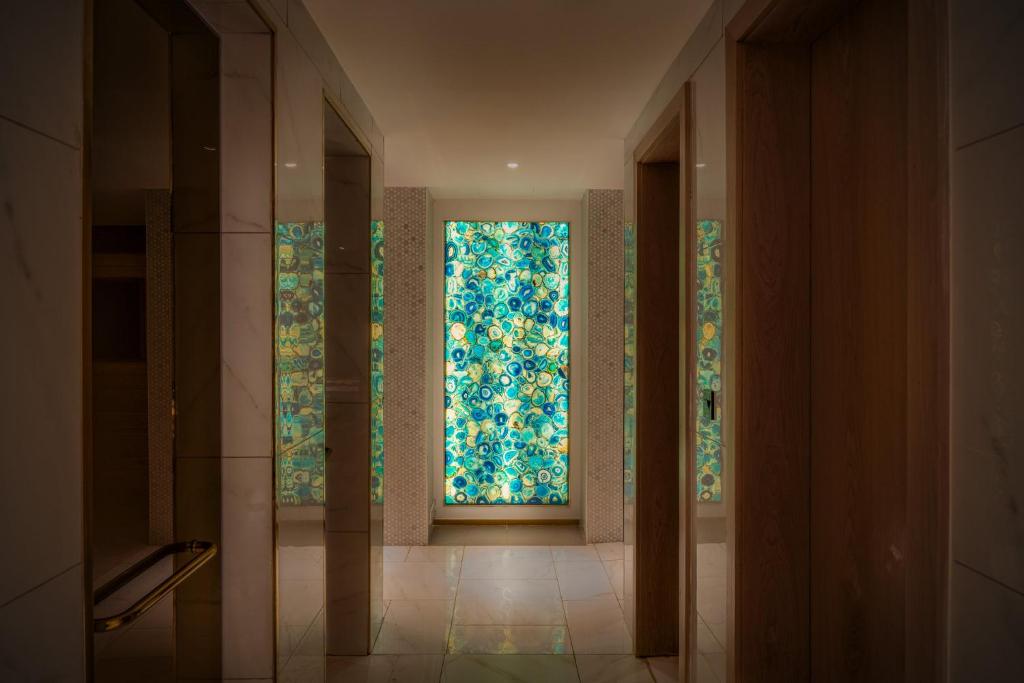 a hallway with a large window in a bathroom at Glee Nairobi, a Preferred LVX Hotel in Nairobi