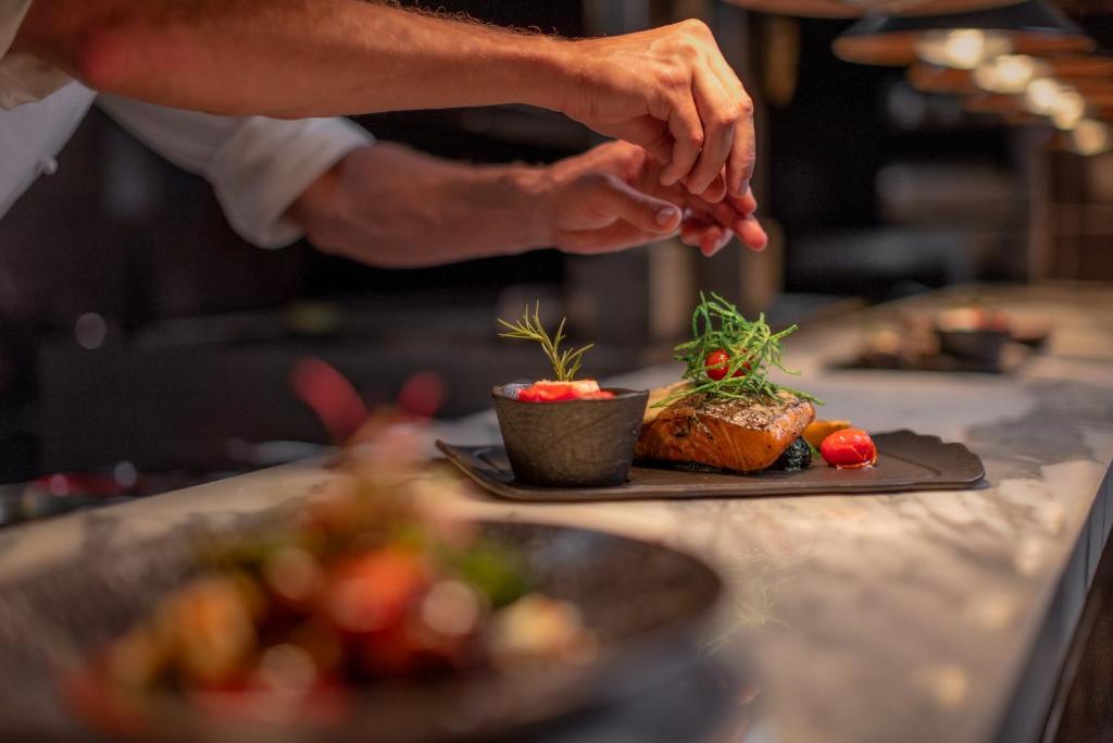a person is preparing food on a table at Glee Nairobi, a Preferred LVX Hotel in Nairobi