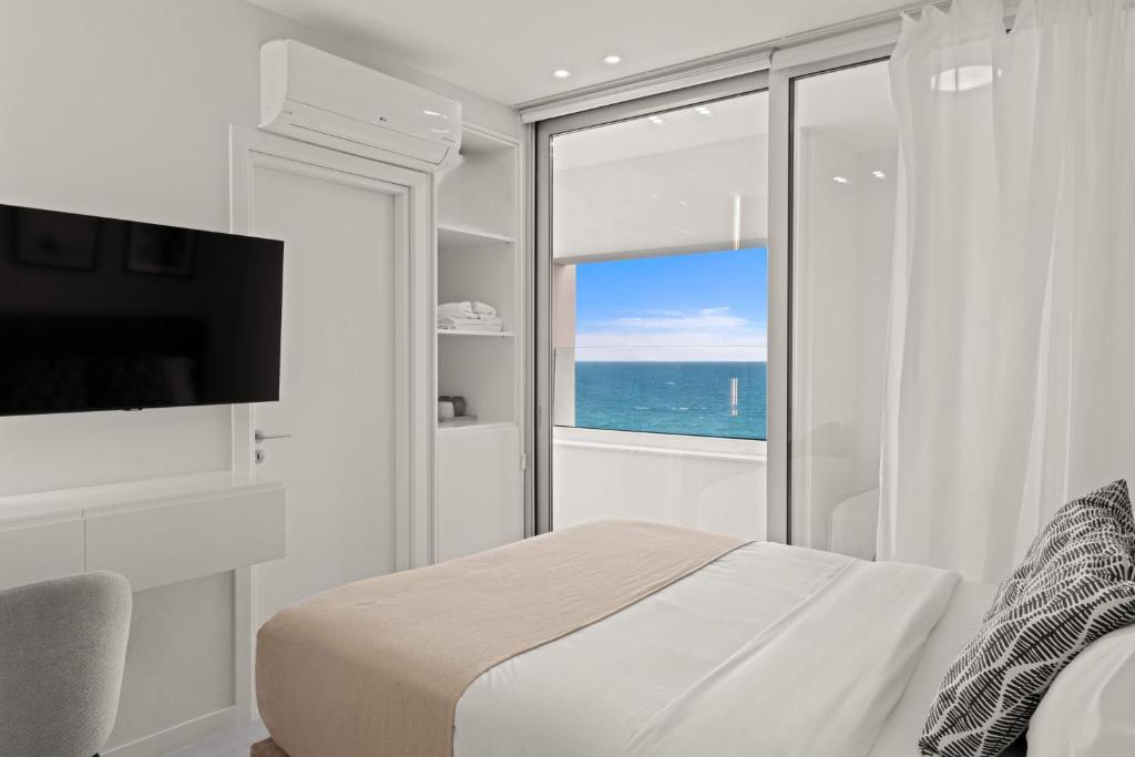 a bedroom with a bed and a view of the ocean at Phaedrus Living: Limassol Seaside Residences 03 in Limassol