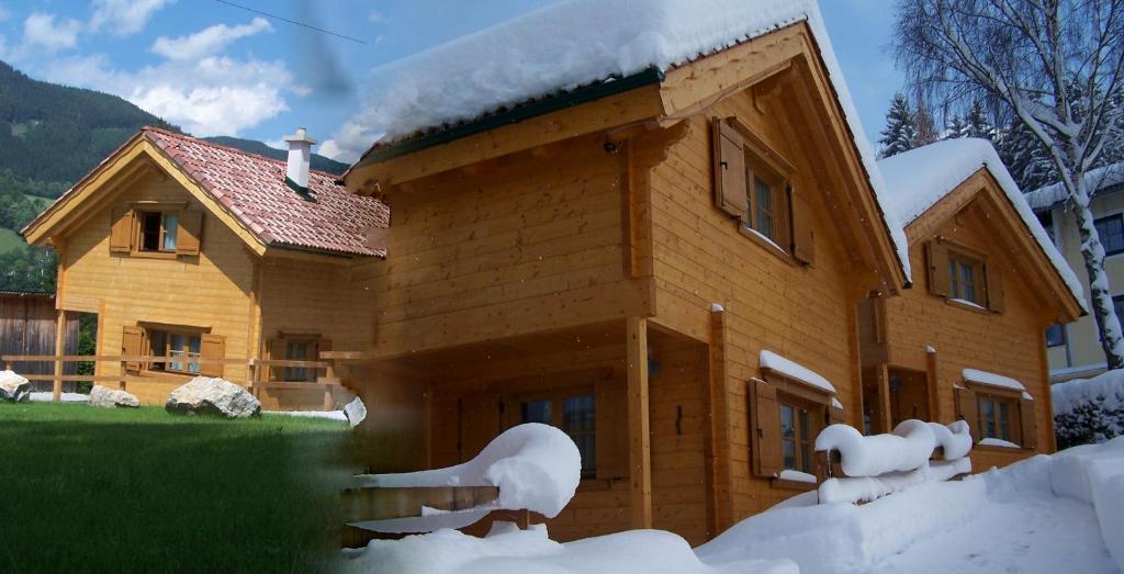 a wooden house with snow on the side of it at Ferienhütten Zimmermann in Spital am Semmering
