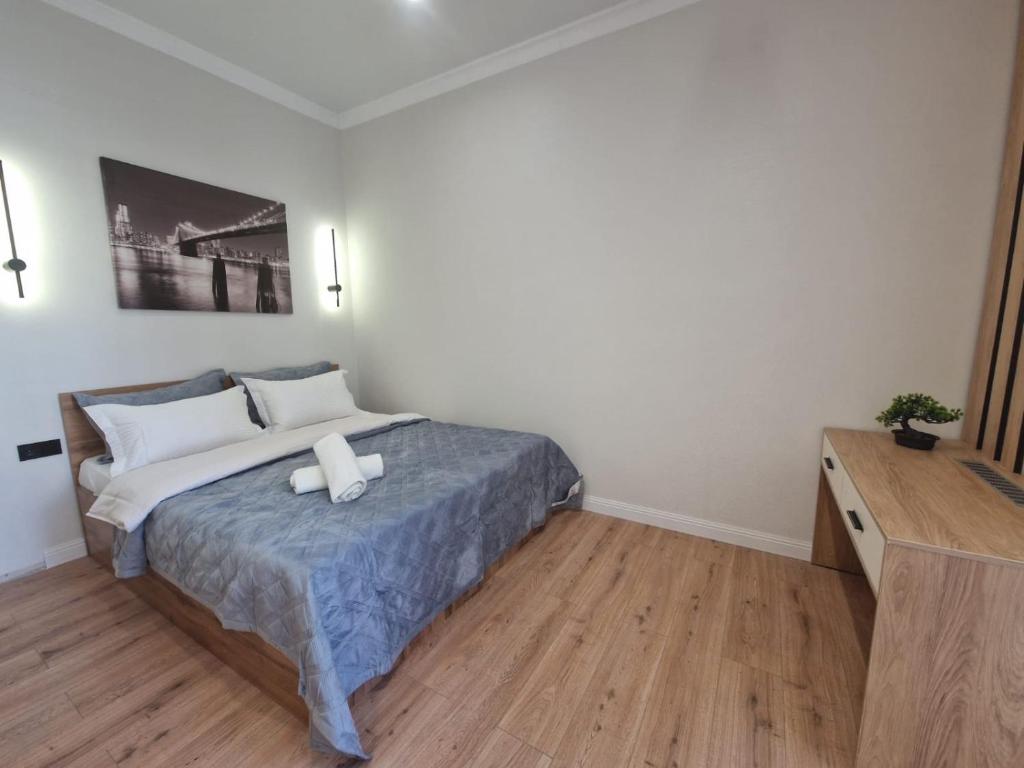 a bedroom with a bed with two pillows on it at Уютная квартира в Бухар Жырау in Astana