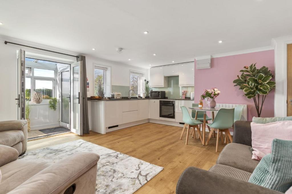 a living room with a couch and a table at The Hidden Valley - a stylish rural retreat, perfect for families in St Clears