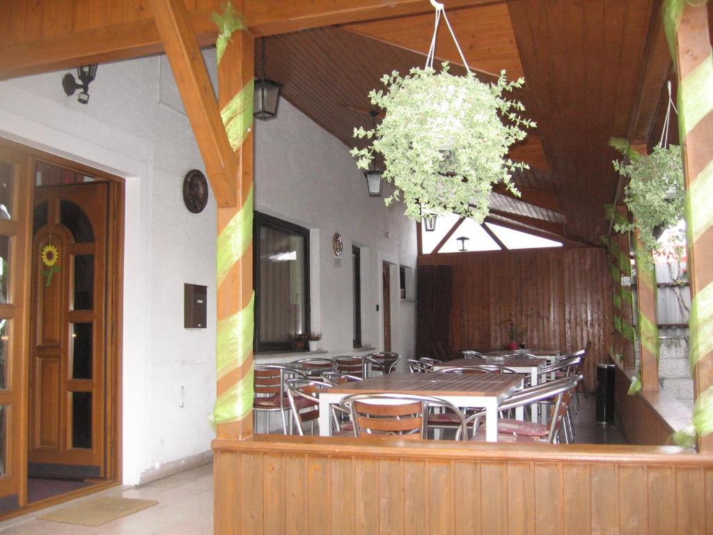 a dining room with a table and chairs in a building at Hattyú Fogadó in Tata