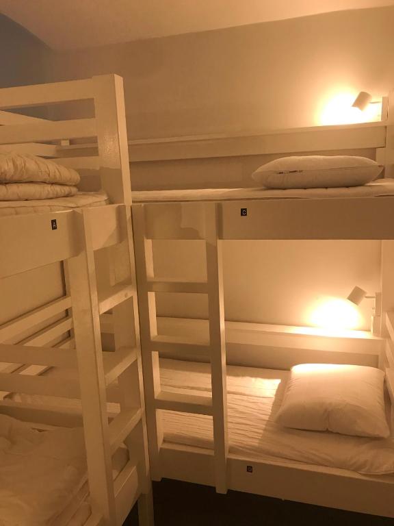a room with two bunk beds with lights on them at Hostel Dalagatan in Stockholm