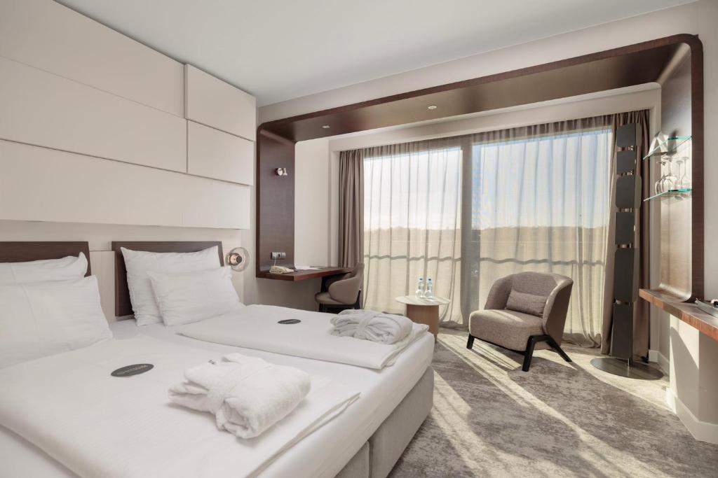 Postel nebo postele na pokoji v ubytování Marine Hotel by Zdrojowa