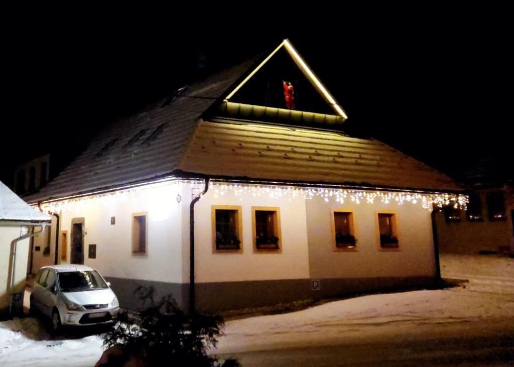 a house with christmas lights on the side of it at Privat LeNa in Ružomberok