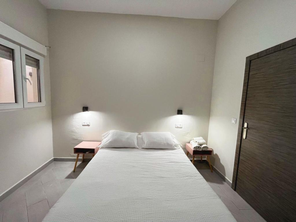 Postel nebo postele na pokoji v ubytování Hostal Pompeya Merida