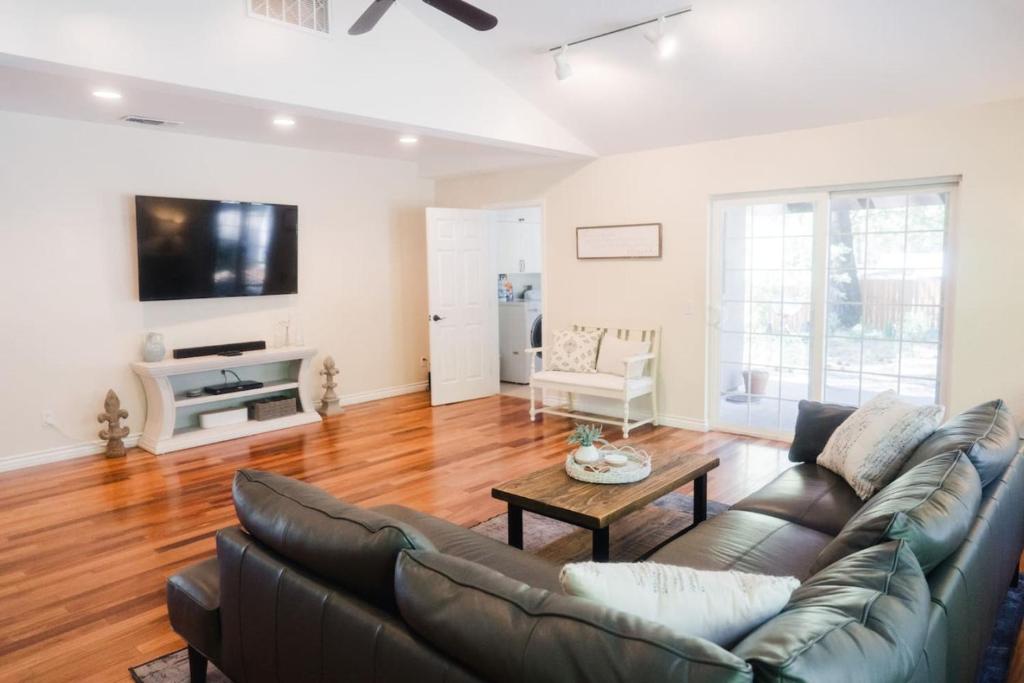 a living room with a couch and a table at Grass Valley Home with Hot Tub in Grass Valley