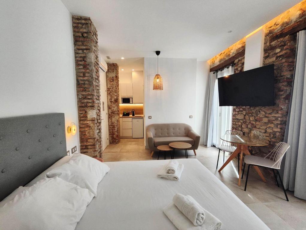a bedroom with a bed and a living room at La estación in Málaga