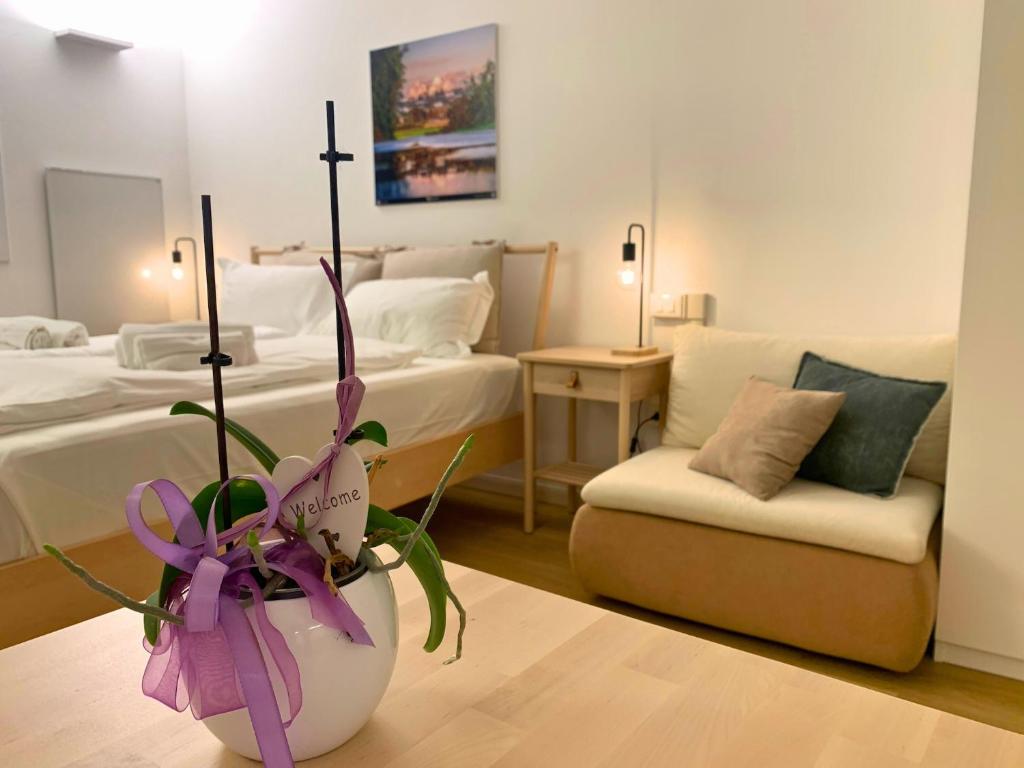 a bedroom with two beds and a potted plant at Borgo Terra village in Fagagna