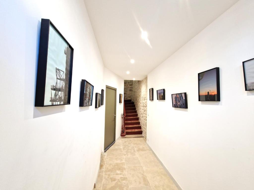a hallway with paintings on the walls of a museum at Sadi Carnot in Arles