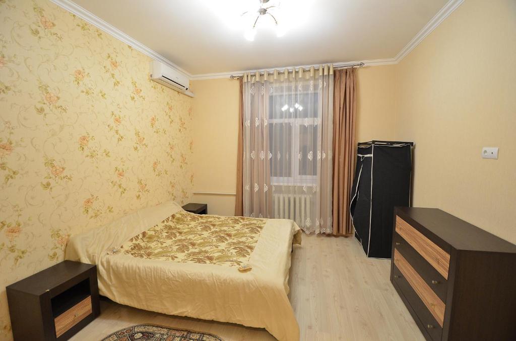 een kleine slaapkamer met een bed en een raam bij Lux Apartment Sobornaya in Nikolayev