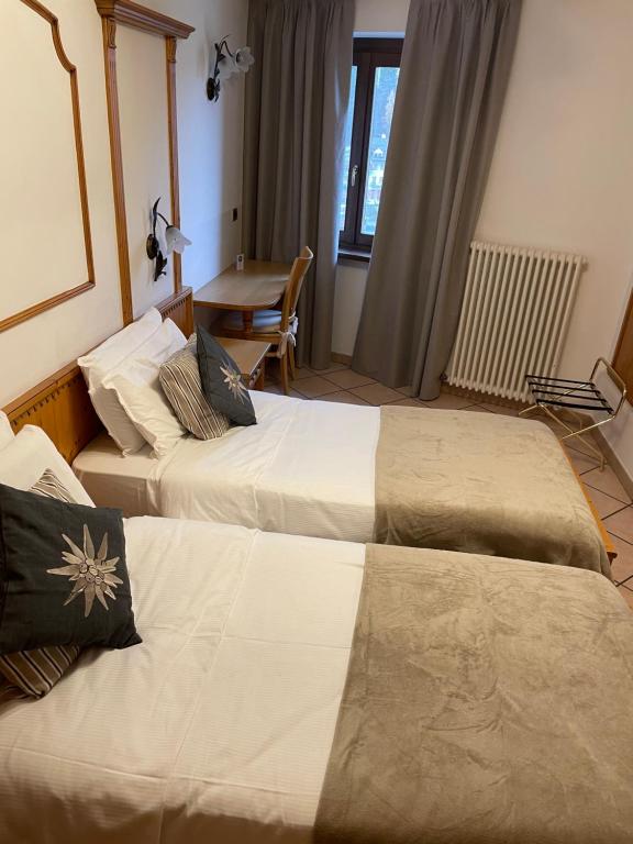 Postel nebo postele na pokoji v ubytování Hotel Valle Verde - Rent Ski & Bike