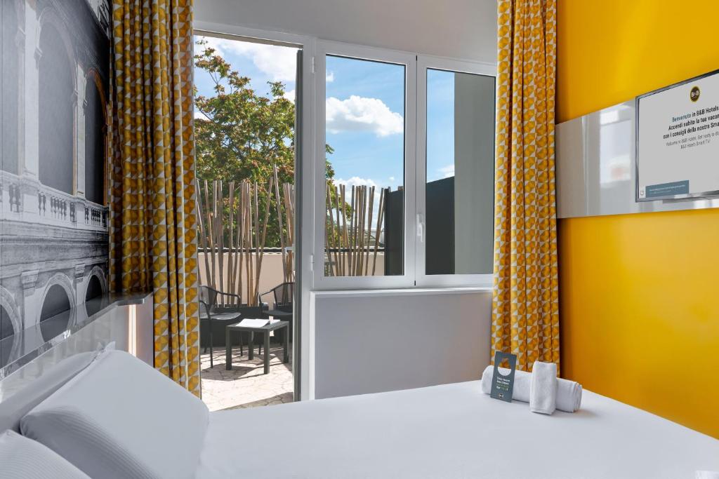 Postel nebo postele na pokoji v ubytování B&B Hotel Roma Pietralata Tiburtina