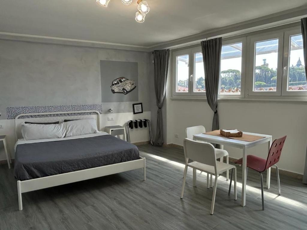 a bedroom with a bed and a table and chairs at La Roma di Camilla in Rome