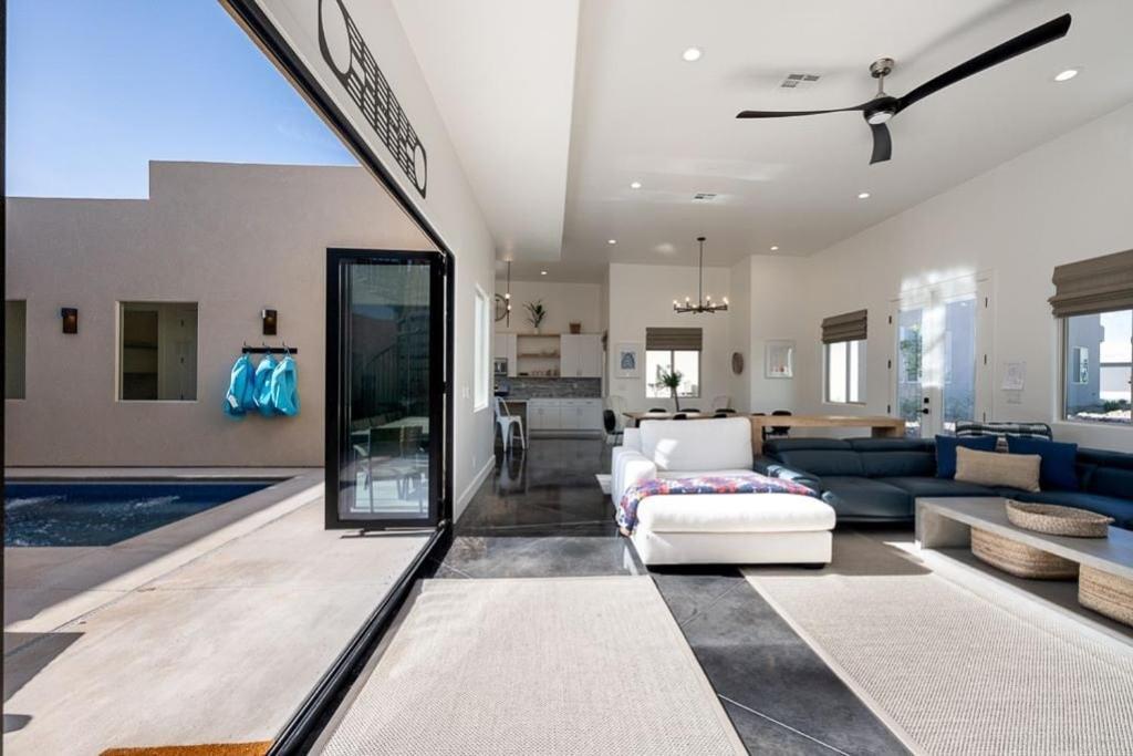 a living room with a couch and a pool at Azure Abode at Sand Hollow Resort in Hurricane
