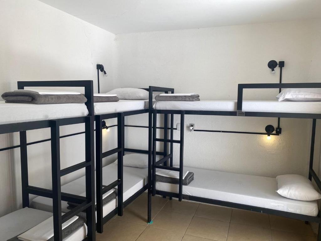 a group of four bunk beds in a room at Reserva 69 Hostel in Sao Paulo