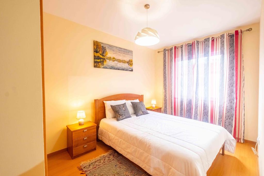 a bedroom with a bed and a large window at Santana House - Holiday Rental in Santana