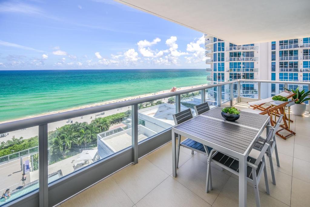 a balcony with a table and a view of the ocean at MonteCarlo Miami Beach in Miami Beach