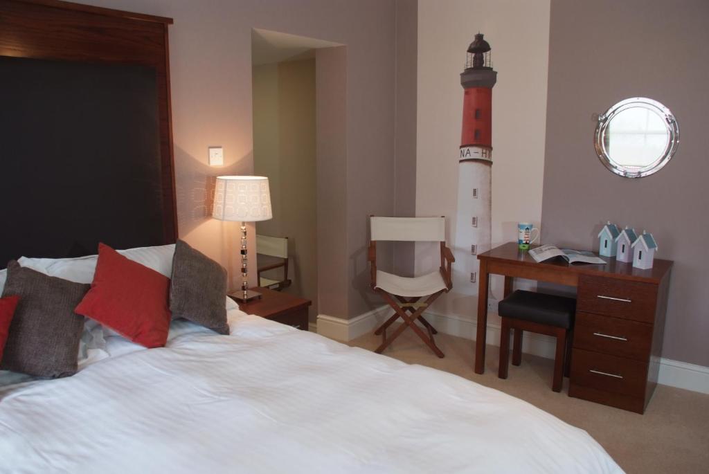 a bedroom with a bed and a light house at The White Horse in Overstrand