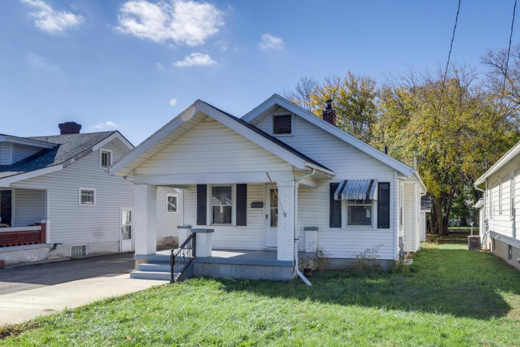 a white house with a porch in a yard at Close to University and Dtwn Home in Dayton in Dayton