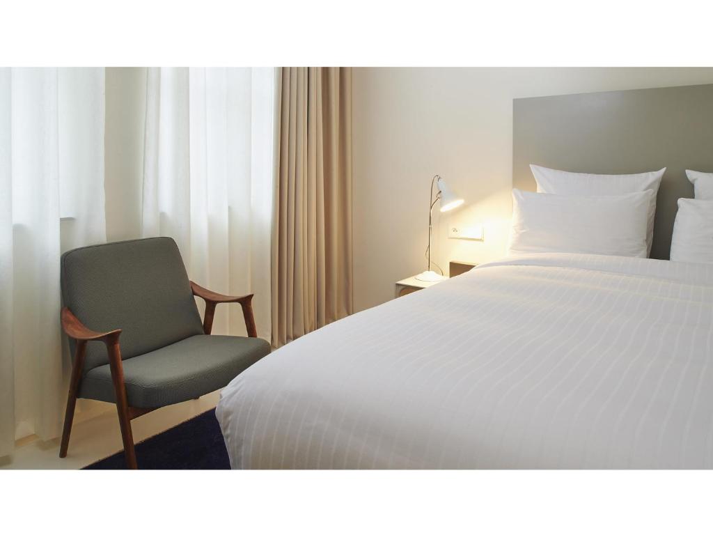 Postel nebo postele na pokoji v ubytování 9Hotel Sablon