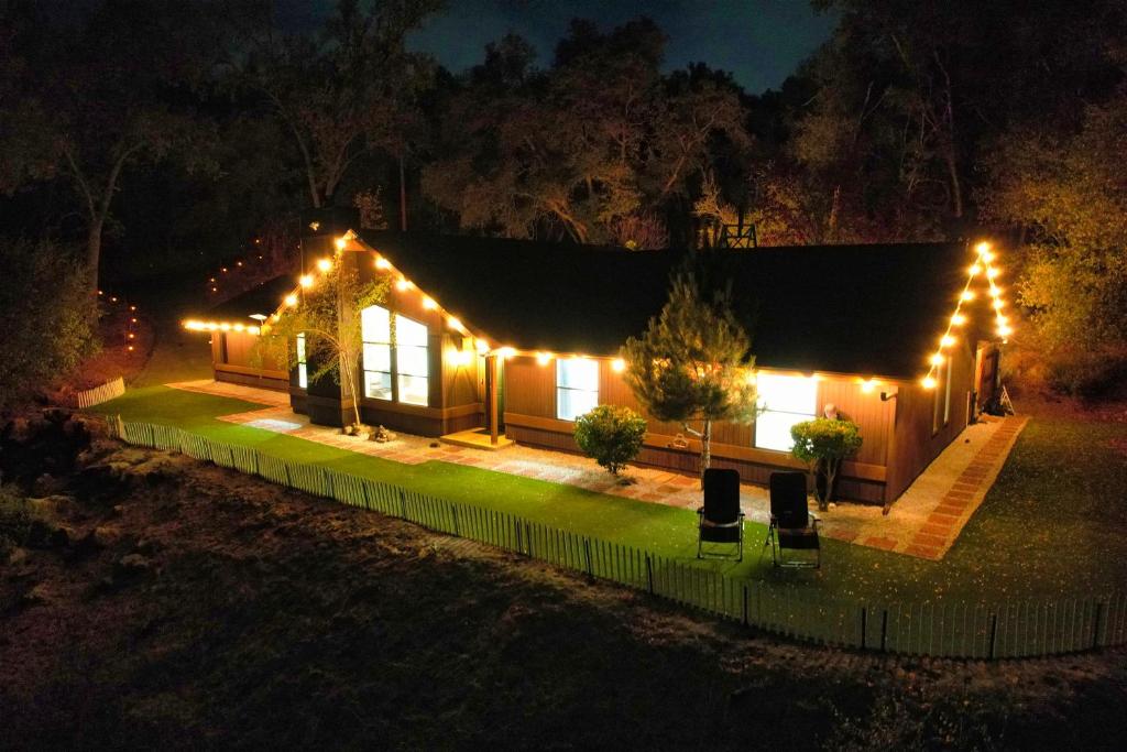 a house lit up at night with lights at Yosemite Forest Villa in Oakhurst