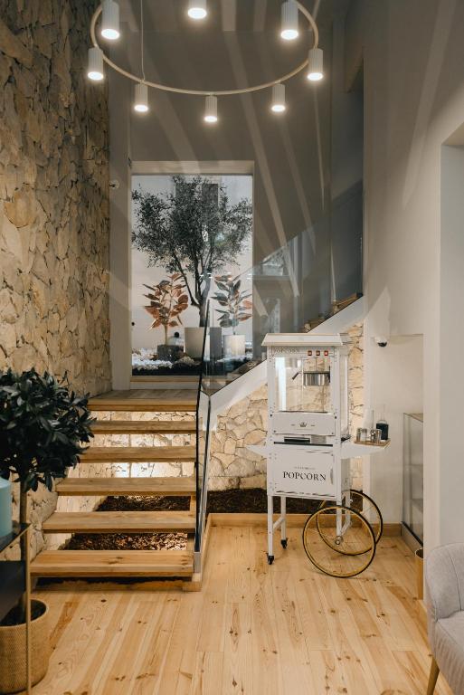 a room with stairs and a tree in a window at M'AR De AR Auria in Lisbon