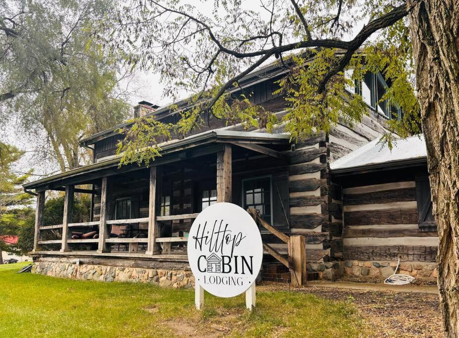 a log cabin with a sign in front of it at The Hilltop Cabin in Goshen