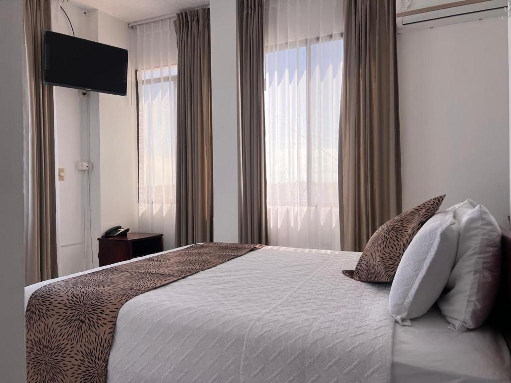 Postel nebo postele na pokoji v ubytování Hostal Carliza
