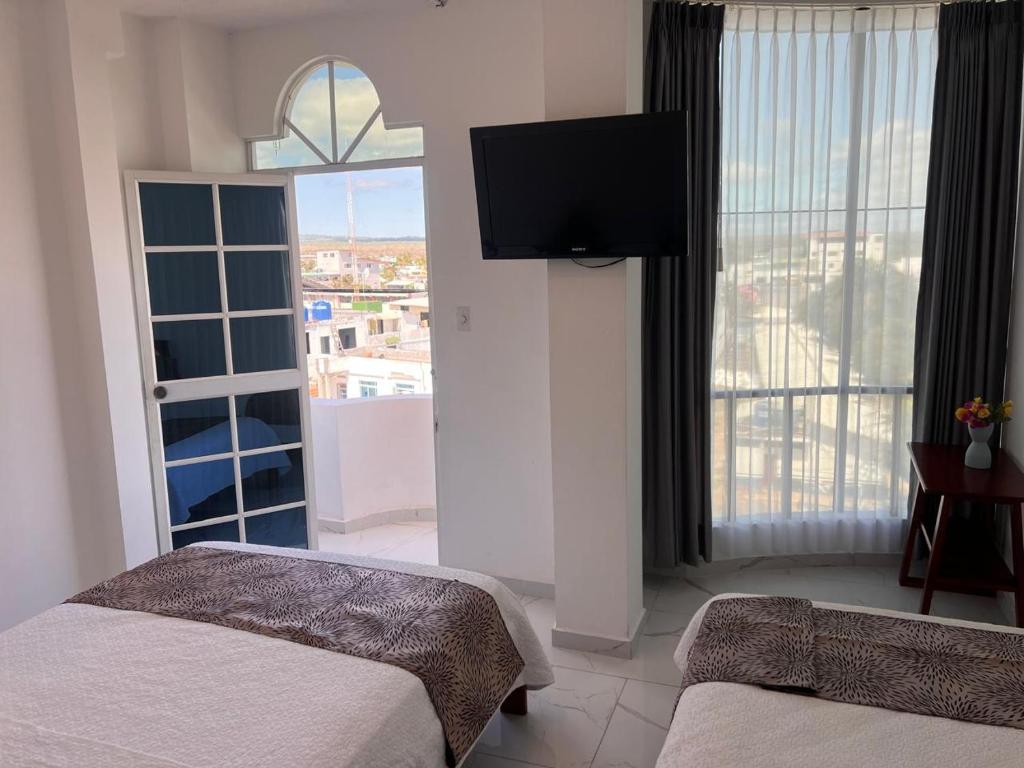 Postel nebo postele na pokoji v ubytování Hostal Carliza