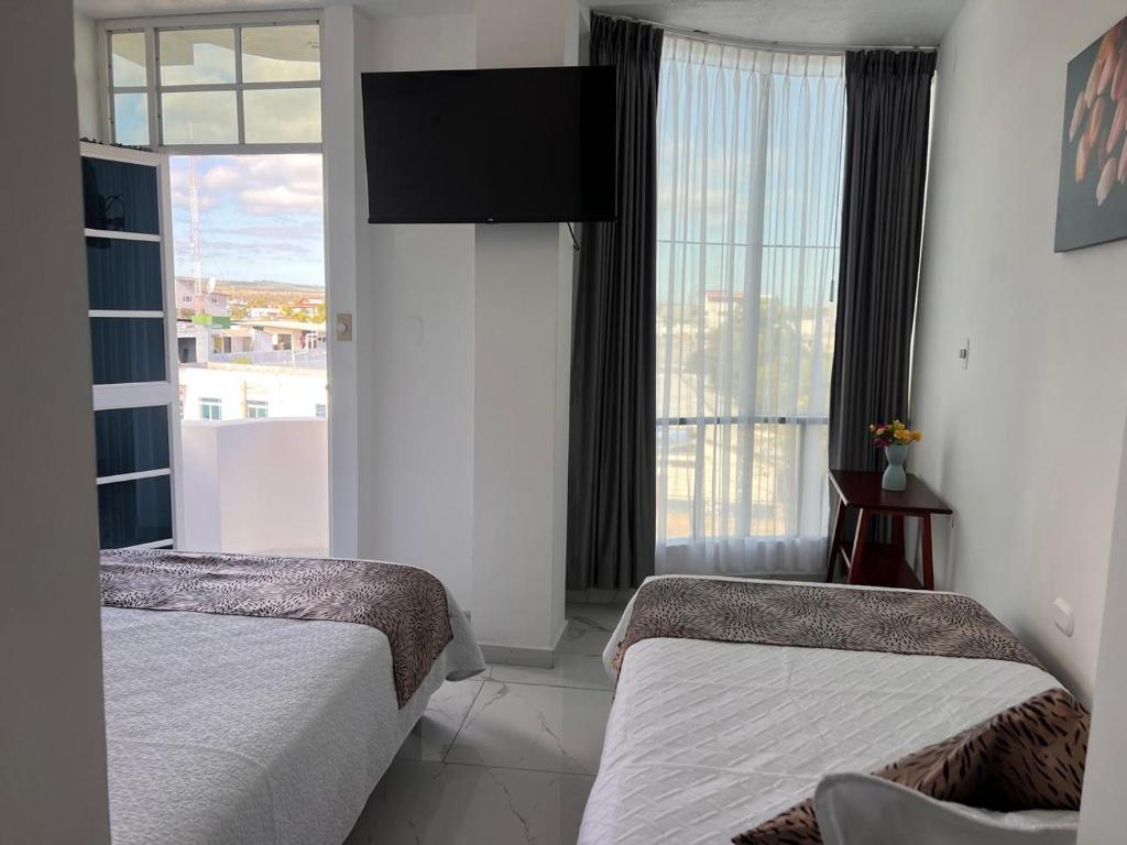 Postel nebo postele na pokoji v ubytování Hostal Carliza