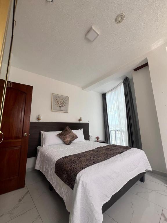 Postel nebo postele na pokoji v ubytování Hostal Carliza