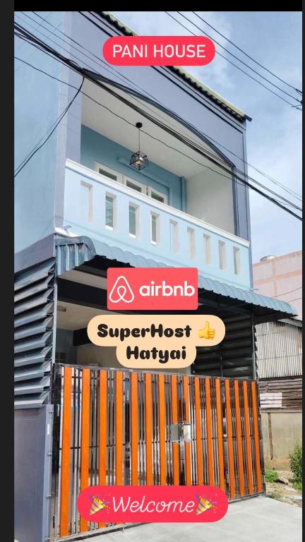 a building with signs on the front of it at Pani House Hatyai 5 in Hat Yai