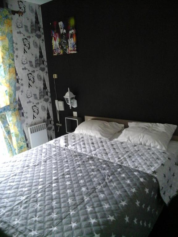 Postel nebo postele na pokoji v ubytování Hôtel l'Eden