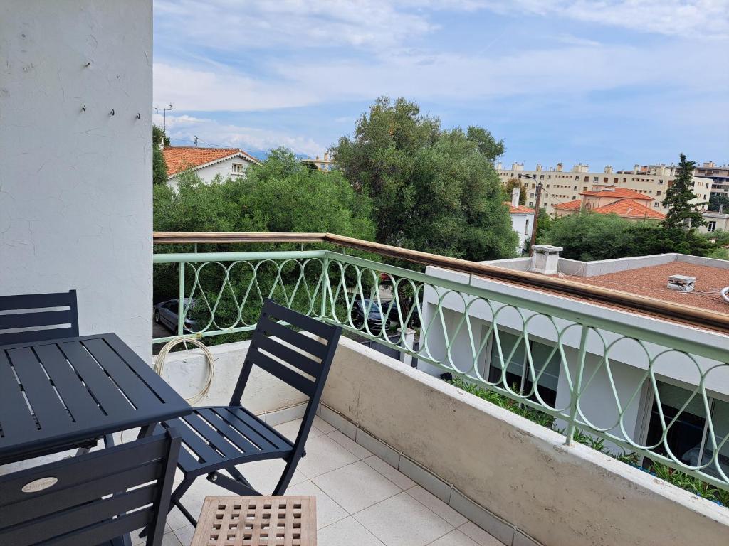 un balcon avec deux chaises et une vue sur une ville dans l'établissement Au calme, plages à pieds, à Antibes