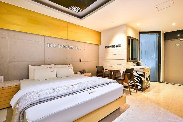 浦项Pohang Cheongha Call Self Check-in Motel的带一张大床和一张桌子的卧室