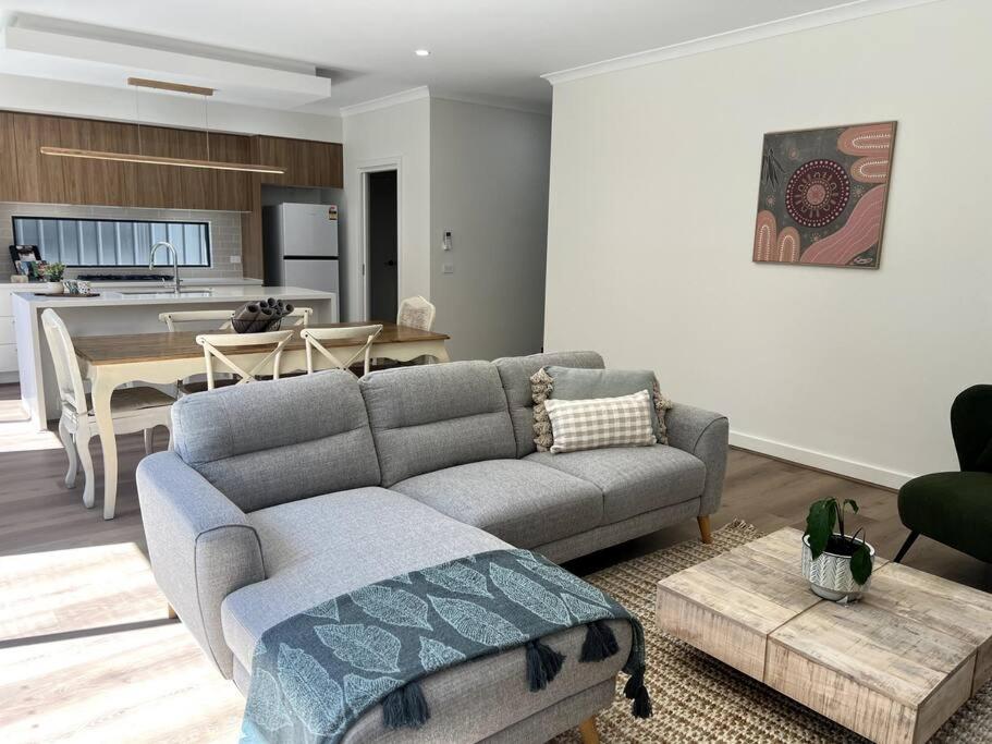 a living room with a couch and a table at The Cosy Cottage in Ararat