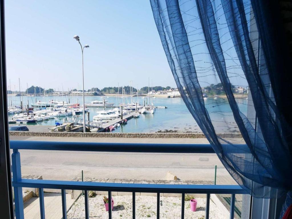 a window with a view of a harbor with boats at Etel: Appartement 3 pièces, Vue Ria, Parking, Animaux admis - FR-1-479-167 in Étel